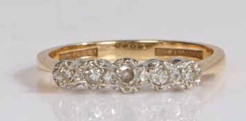 An 18 carat gold diamond set ring, with five round cut diamonds to the head, ring size P, 2.8g