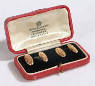Pair of 10ct gold cufflinks, the oval heads with foliate decoration, 4.8g, housed in a red leather