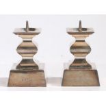 Pair of Continental silver pricket candlesticks, the square drip pans above waisted square stems,