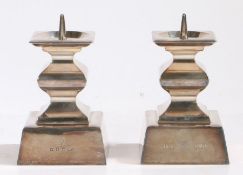 Pair of Continental silver pricket candlesticks, the square drip pans above waisted square stems,