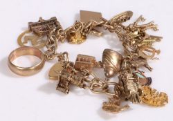 9 carat gold charm bracelet, with a collection of various charms, 64 grams