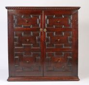 18th Century and later oak cupboard, with two geometric moulded panel cupboard doors opening to