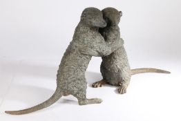 Cast metal sculpture depicting two meercats, modelled standing on their back legs, 82cm wide, 38cm
