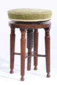 A Victorian mahogany piano stool, the circular adjustable top above four tapering reeded legs,