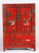Chinese red lacquered side cupboard, 20th century, painted with figures within a garden setting, the
