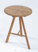 Late 19th century pine cricket table, the circular top raised on three turned legs and T