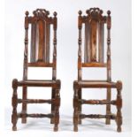 A pair of William & Mary style high-back chairs, with pierced and scroll-carved cresting rails,