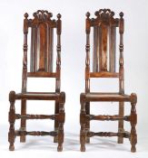 A pair of William & Mary style high-back chairs, with pierced and scroll-carved cresting rails,
