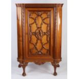 Eric Bates mahogany cupboard, the panelled cupboard door with tracery mouldings and central carved