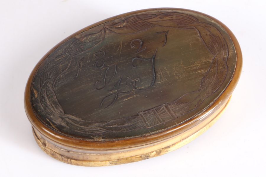 19th Century horn snuff box, of oval form, the lid initialled GJ and dated 1827, 8cm wide