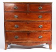 Victorian mahogany and crossbanded bow-front chest of two short and three long drawers, the swing