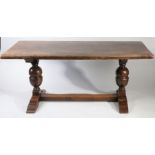 20th century oak refectory dining table, the rectangular top raised on large baluster supports
