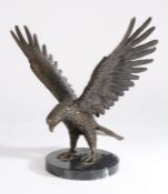 20th Century bronze eagle, modelled in a standing position with wings spread, raised on a black