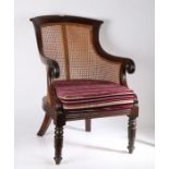 19th century mahogany and cane bergere chair, with a curved cresting rail above a cane back and seat