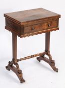 Victorian rosewood games table,, the rectangular folding top opening to reveal a red baize lined