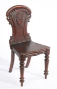 Victorian mahogany hall chair, the pierced scroll carved back with central vacant shield, the