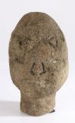 Primitive carved stone head wearing a crown, 30cm high