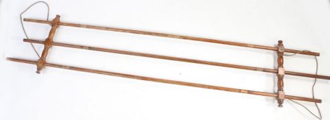 Early 20th century pitch pine drying rack, with three long rails, 253cm long