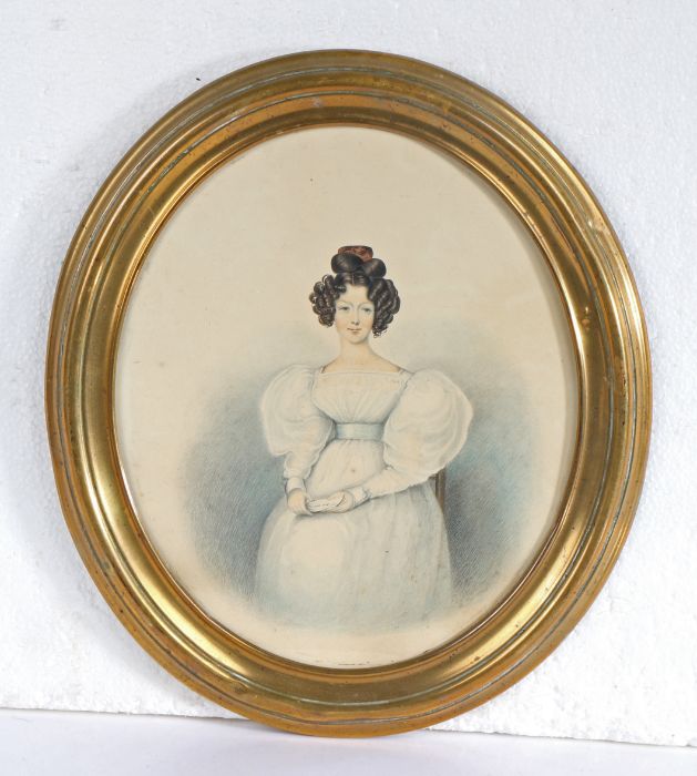 Regency watercolour portrait of a lady holding a letter, housed in a glazed oval brass frame, the