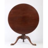 George III mahogany tripod table, the circular tilt top raised on a turned stem and tripod legs,