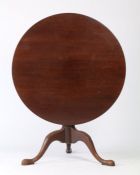 George III mahogany tripod table, the circular tilt top raised on a turned stem and tripod legs,