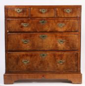 George III and later walnut chest of three short and three long drawers, with brass swan neck