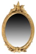 Victorian oval wall mirror, the gilt frame with foliate and fern leaf decoration, 63cm wide, 97cm