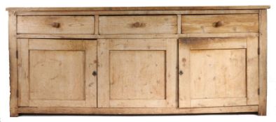 A 19th Century pine dresser base, the rectangular top above three short drawers and three cupboard