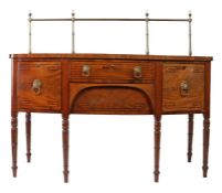 Regency mahogany sideboard, the brass back rail with urn finials, the bow-front sideboard with