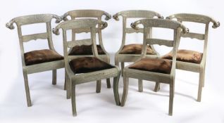 Set of six embossed metal dining chairs, the arched cresting rails with rams head terminals, with