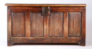 A 17th century cedar linen fold coffer, circa 1600, the hinged lid above four linen fold panels,