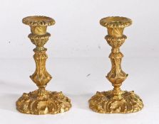 Pair of 19th century Rococo style ormolu candlesticks, with gadrooned sconces, acanthus leaf and