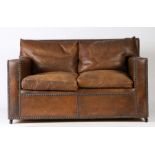 1920's brown leather club style settee, with studded upholstery, loose back and seat cushions, 135cm