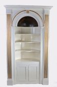 Victorian white and gold painted standing corner cupboard, the stepped pediment above an arched