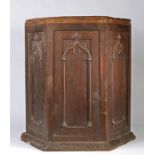 An unusual hexagonal gothic cupboard, with two arched effect panelled cupboard doors and matching