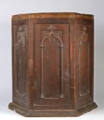 An unusual hexagonal gothic cupboard, with two arched effect panelled cupboard doors and matching