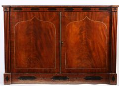 A Regency mahogany press cupboard, the rectangular top above an inlaid frieze and a pair of strung