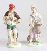 Pair of 19th century Dresden figures, depicting a fisherman holding two fish and with a fish