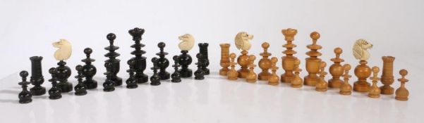 A Regence pattern chess set, French late 19th century, turned boxwood and ebony pieces with carved