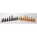 A Regence pattern chess set, French late 19th century, turned boxwood and ebony pieces with carved