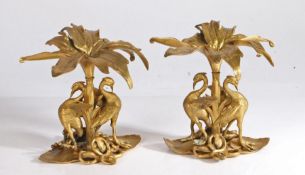 A pair of 20th century gilt metal table decorations, modelled as two birds with wings outspread