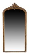 19th century gilt over-mantle mirror, with a floral and scroll carved pediment, and an arched