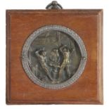 Early 19th Century medallion depicting Vulcan's forge, housed in a wooden frame, the medallion 6cm