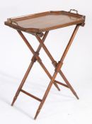 Edwardian walnut tray on stand, the tray with in-swept corners and brass carrying handles, on a