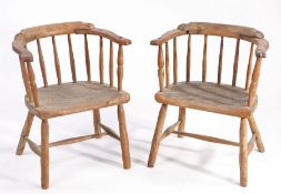 Pair of early 19th century oak child's chairs, with bowed back rail and spindled back rest, solid