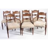 Seven Regency mahogany dining chairs, having fluted top rail and lozenge shaped pierced splat backs,