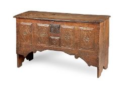 A rare Henry VIII oak boarded chest, circa 1540 The near one-piece lid with triple-moulded edge, the