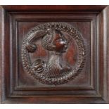 A Henry VIII carved oak Romayne-type portrait panel, English, circa 1540 Carved in high relief, a