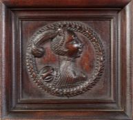 A Henry VIII carved oak Romayne-type portrait panel, English, circa 1540 Carved in high relief, a