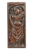 An Elizabeth I carved oak figural panel, circa 1580 Designed as the Theological Virtue Charity (